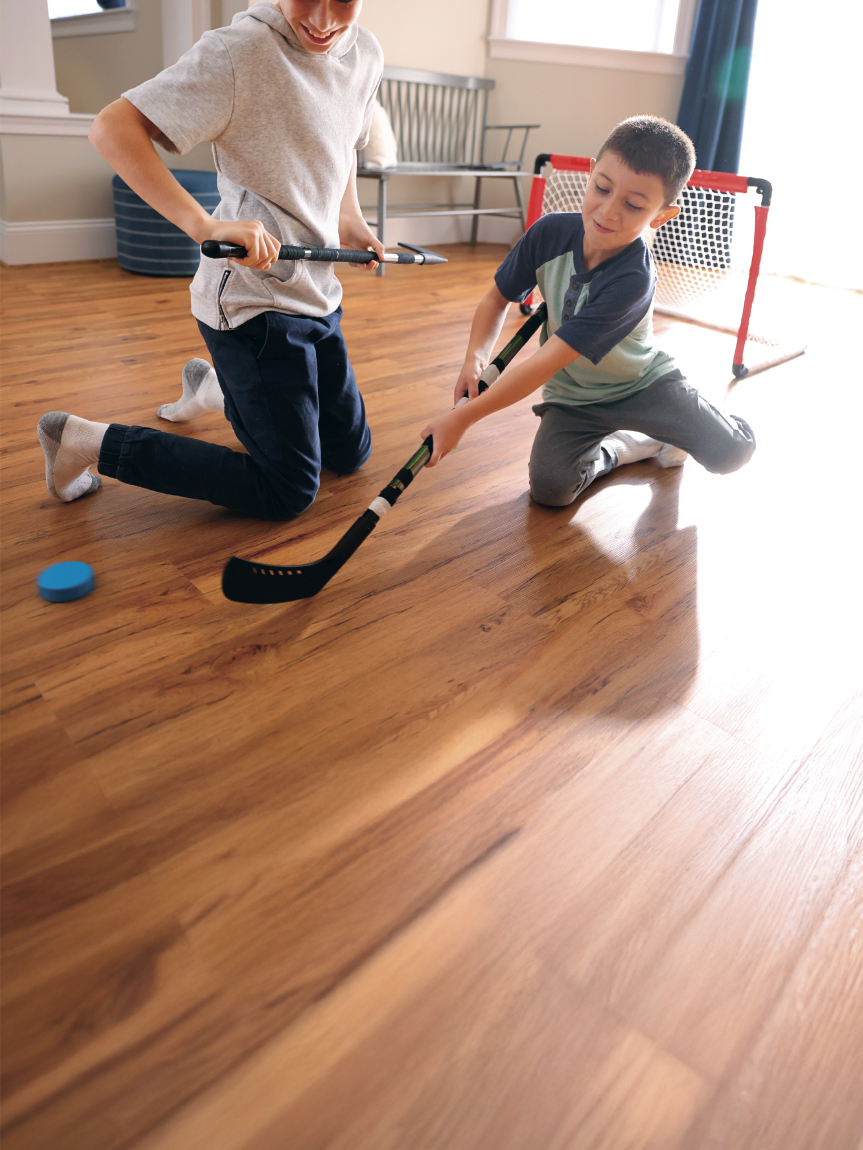 Family playing games in a living room with a hardwood floor